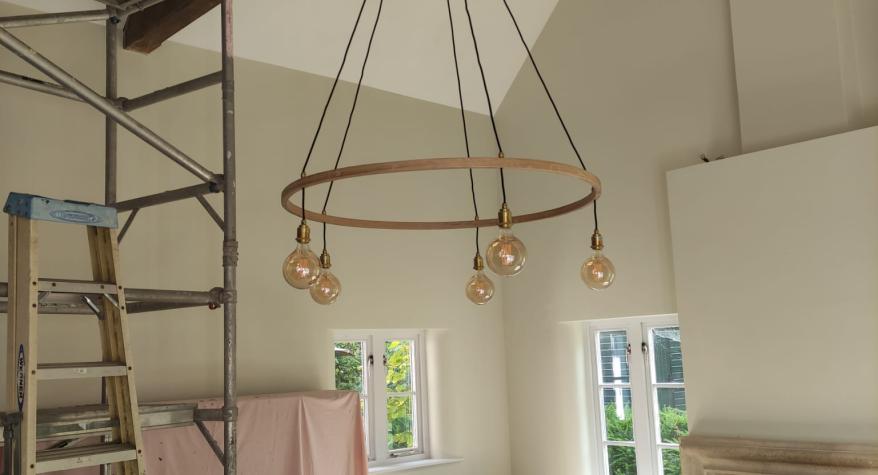 A new decorative wooden chandelier with warm white LED bulbs.