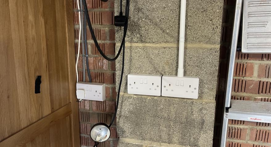 Installation of 2x new double sockets in a garage in Corsham with the cables contained in PVC conduit 